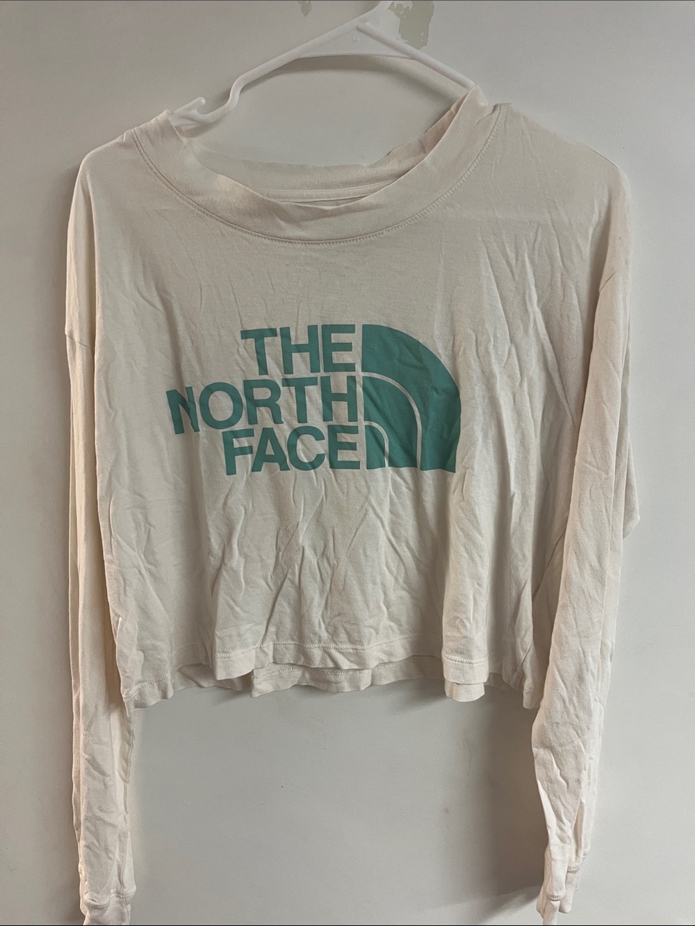 The North Face Cream Cropped Long Sleeve Tee with Teal Logo